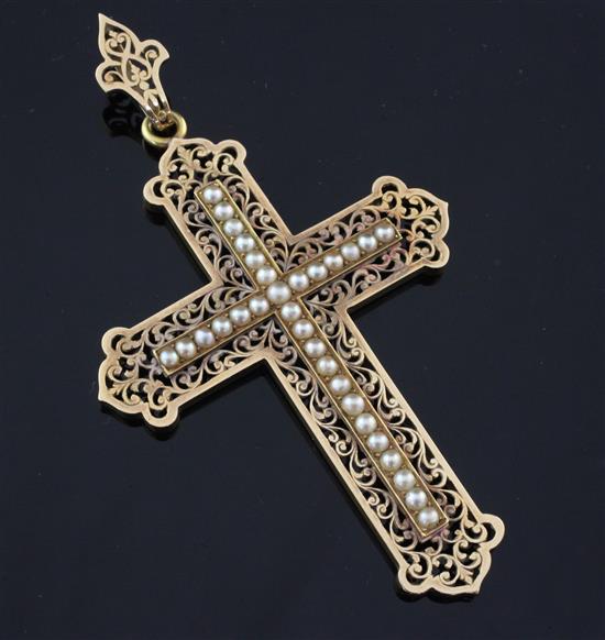 An early 20th century unmarked gold and split pearl set cross pendant, overall 3.75in.